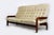 A striking mid-century living room set consisting of a three-seater sofa and a pair of matching low lounge armchairs,...