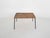 About this item Rattan coffee table with black metal outstanding feet. Small traces of use consistent with age and use.