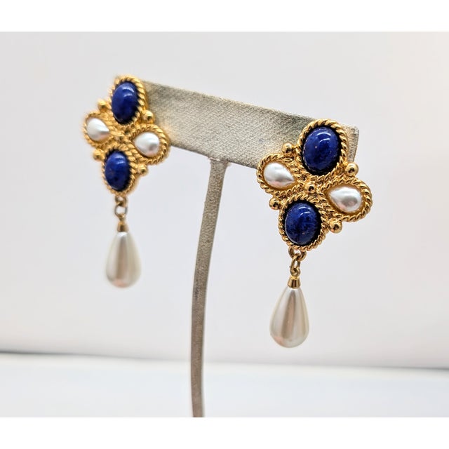 Goldtone cabochon faux-lapis and faux-pearl with faux-pearl drop pierced push back earrings. Marked "Napier." Measure: 2...