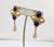 Goldtone cabochon faux-lapis and faux-pearl with faux-pearl drop pierced push back earrings. Marked "Napier." Measure: 2...