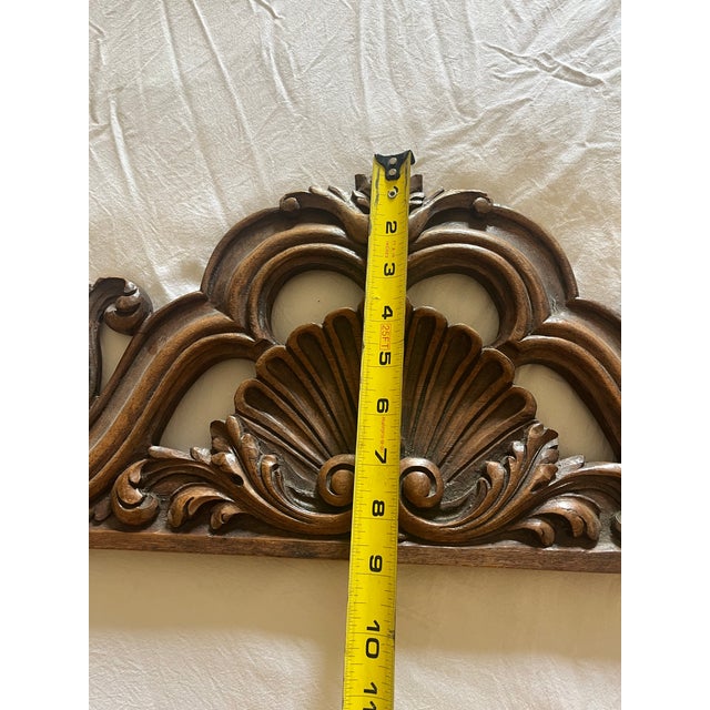 Hand carved wood pediment. This Detailed wood carving features floral and scroll elements. The ornate design showcases a...