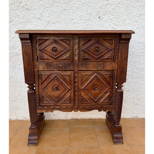 An exceptional and highly unusual Spanish sideboard, featuring an impressive architectural design and richly carved...