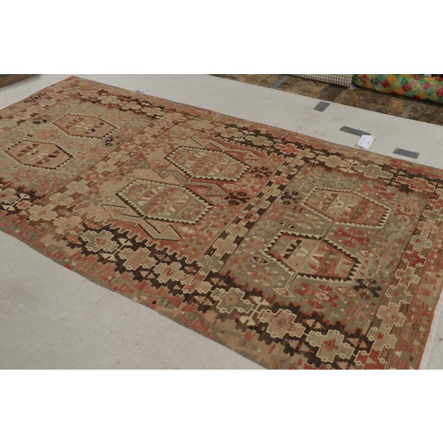 Originating from Turkey between 1940-1950, this vintage Esme wool Kilim rug features a high-quality flat-weave and a...