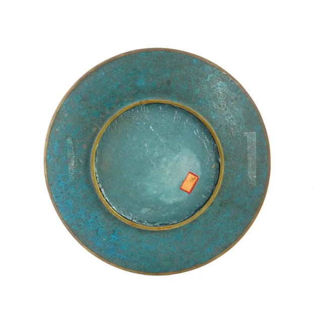 A high quality antique Japanese, late Meiji era, enamel plate. The interior of the plate is adorned with a polychrome...