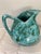Studio art pottery pitcher in a striking turquoise crystalline spotted glaze, likely mid-to-late 20th century. The base is...