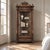 A 19th century French Henri II bookcase and display armoire in blonde walnut, trimmed with ebonized moldings and set with...