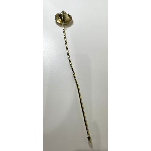 Vintage brass candle snuffer with twisted handle. Length is 13" with a weight of 2 oz.