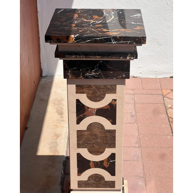 A handsome marble pedestal, Italy 20th century. In tones of chocolate, caramel, and heavy cream, and hand-crafted with a...