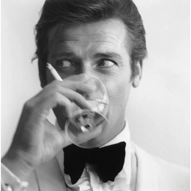 Shaken not Stirred, 1968 - 007 James Bond Roger Moore Portrait Tuxedo Martini Roger Moore casts a glance away from the...