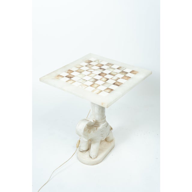 Italian craftsmanship, circa 1950-1970 A rare, decorative vintage game table with a solid, carved elephant base to which a...
