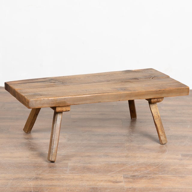 The appeal of this rustic coffee table comes from the thick hard wood top that originally served as a work table, resting...