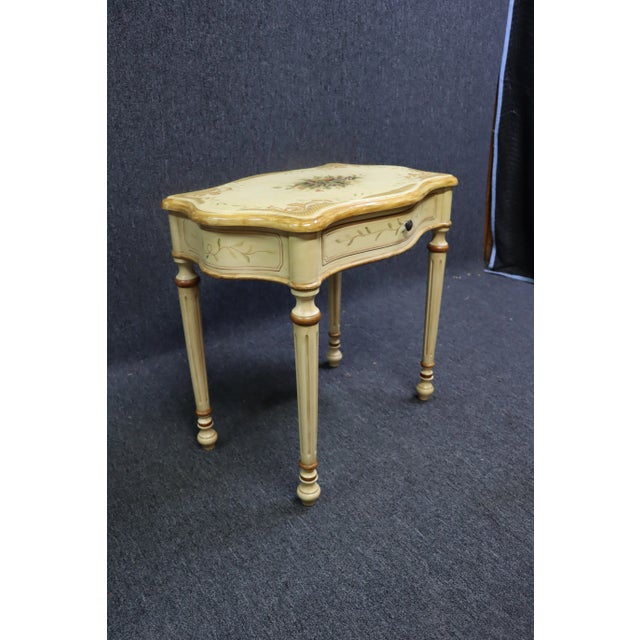 French Style Cream Painted and Gilt Serpentine Side Table, cream painted with gilt highlights, applied fruit decoration on...