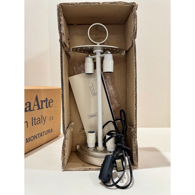 Authentic FontanaArte Pirellina table lamp designed by Gio Ponti. Frosted textured curved glass with satin metal mounts...