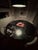 A striking round dining table with a solid slab of black Italian marble on top and sculptural oak pedestal base. The...