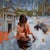 This oil on panel artwork presents a serene figure gently interacting with water, capturing a moment of introspection. The...