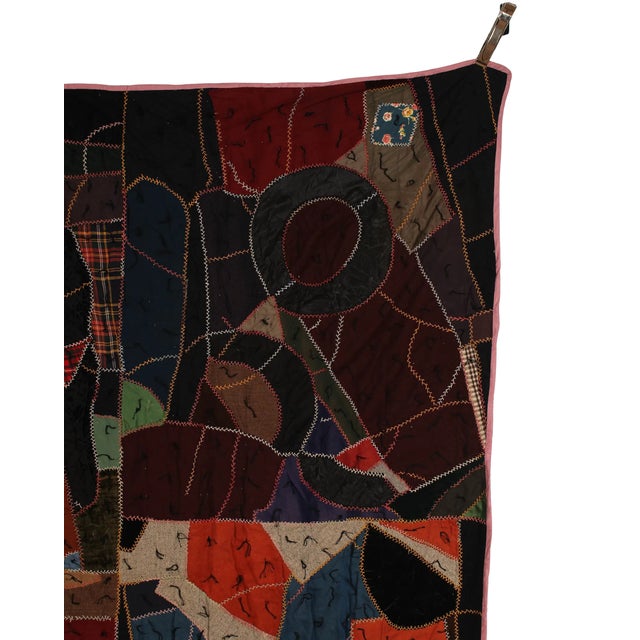 An exceptional vintage crazy quilt with a richly layered patchwork composition and hand embroidered stitching throughout....