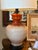 Handsome vintage ceramic lamp with a ribbed cream glaze and a striking persimmon-orange accent. A sophisticated Mid-...