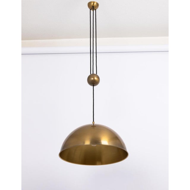 Stunning adjustable counterweight dark brass pendant lamp onos by florian schulz germany 1970s it is a masterpiece of...