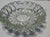 crafted in heavy pressed glass, featuring a crisp starburst motif that radiates from the base and a faceted, scalloped rim...