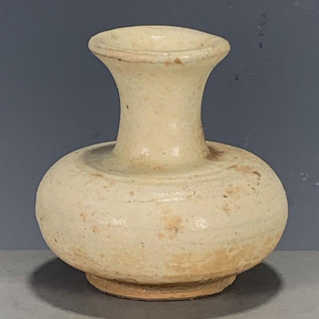 This is a charming vintage pottery vase, crafted from earthenware with a rustic, hand-thrown character. The vase features...
