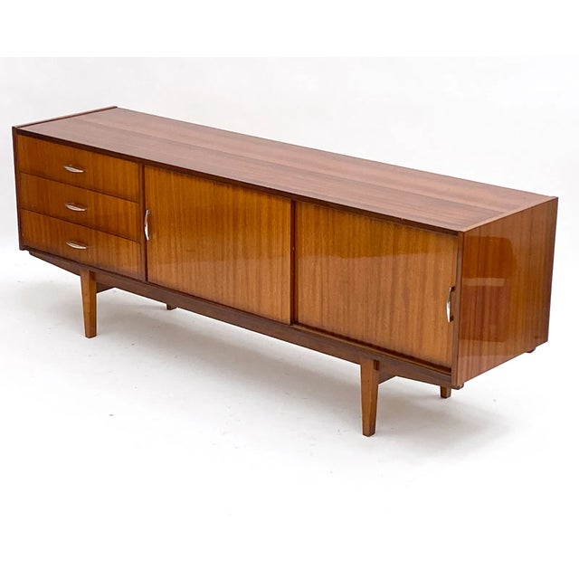 Elegant and elongated, this "Hamilton" style sideboard is expertly crafted from rich French mahogany and showcases the...
