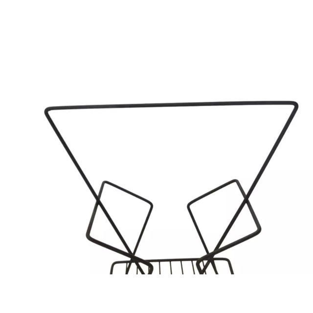 We have for your consideration a very beautiful mid century modern vintage magazine rack from the 1950s in an atomic...