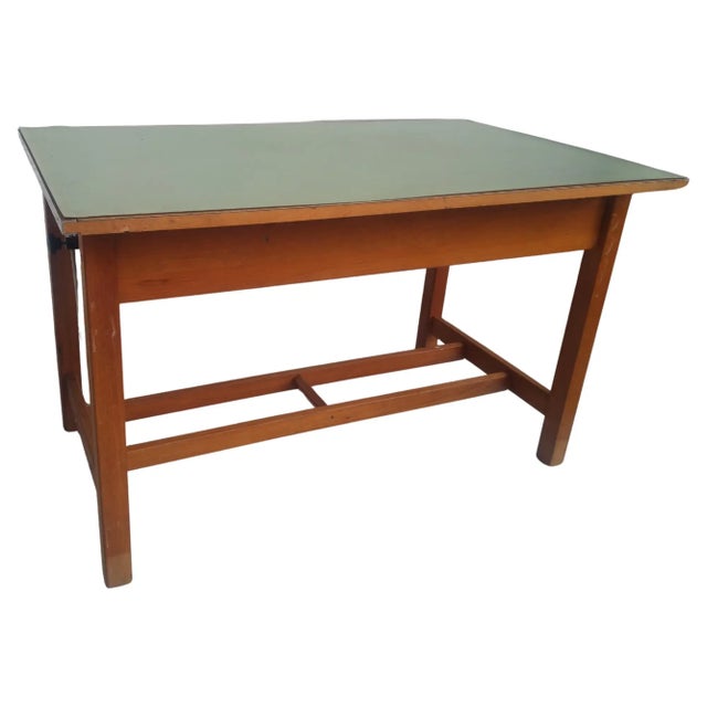 This is a vintage drafting table from the early 20th century. It's made of solid oak and has through tenons. The top can...
