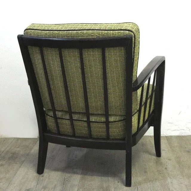 Vintage armchair manufactured in Germany between 1950 and 1955. It features the original upholstery and the wood remains...