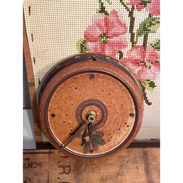 Stamped Stoneware wall Clock with floral detail. Not confirmed operational. Vintage condition as Pictured. Listing is only...