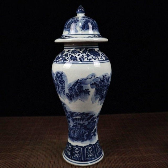 Stately Chinese chinoiserie porcelain Ginger Jar with fitted domed lid. The body is hand‑decorated in classic cobalt blue...