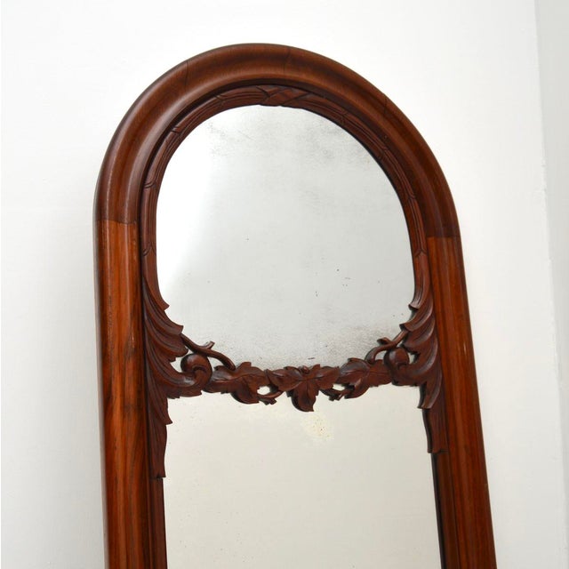 A beautiful antique Victorian carved walnut mirror, made in England and dating from around the 1850-1870 period. It is of...