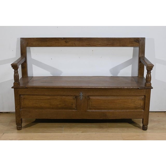This regional solid oak piece of furniture combining the functions of a bench and storage, has a large chest whose front...