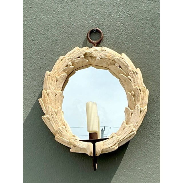 Showcasing classical motif details, this vintage wall mirror features a sculpted circular frame styled in a naturalistic...