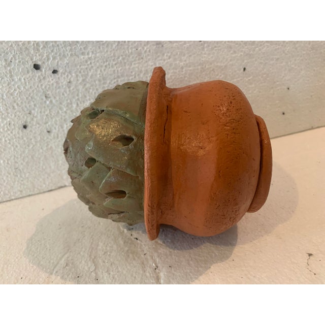 Terracotta and glazed stoneware soliflore vase depicts an artichoke in a terracotta pot bearing the artist's signature "j...