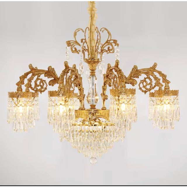 A grand palace-style chandelier crafted for dramatic luxury interiors. This statement lighting piece features an ornate...