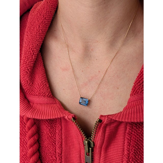 An 8.28-carat London Blue Topaz takes center stage in this clean, modern solitaire design. Set in 14K yellow gold with an...