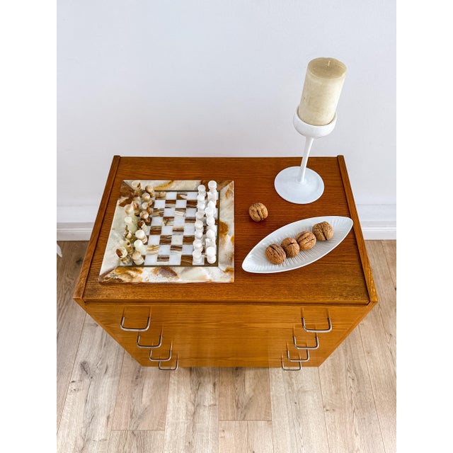 A small, well-proportioned chest of drawers made in czechoslovakia in the 1960s. It has four deep drawers with chrome wire...