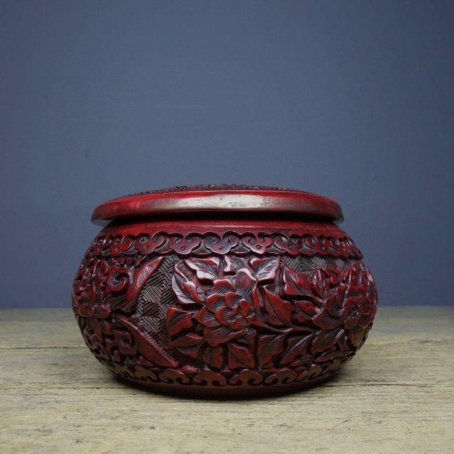 Beautiful lidded jar crafted in traditional Chinese cinnabar / tihong lacquer‑carved style. The exterior features deeply...
