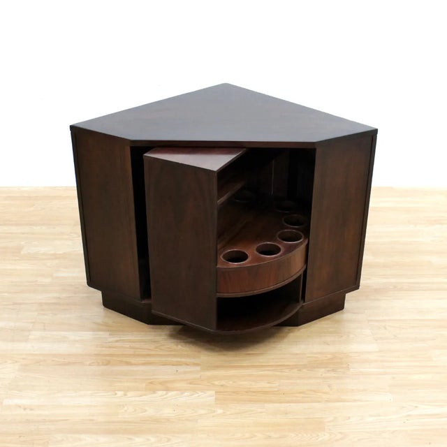This fabulous mid century corner bar cabinet was manufactured by Vildbjerg Mobelfabik in Denmark during the 1970s....