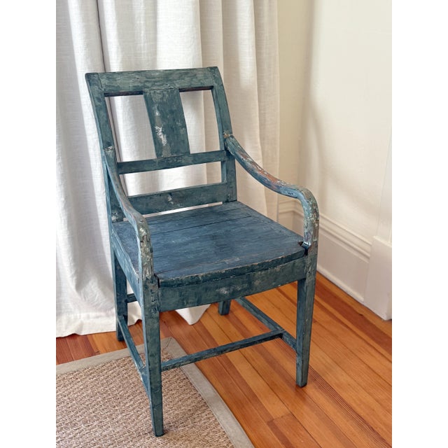 Early 1800's Swedish chair, with the original deep blue paint. Sturdy, with curved arms, a tiered backrest and tapered...