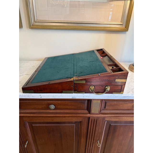 A fine 19th-century campaign writing box, designed for portability and utility during travel. Constructed from rich, solid...