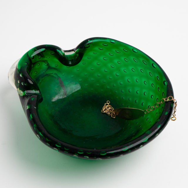 Vintage emerald green Murano glass catchall dish featuring the bullicante controlled bubble technique, with small air...