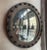 Custom, industrial, mirror features a round, stained pine, frame surrounded by dowels that was originally a reclaimed...