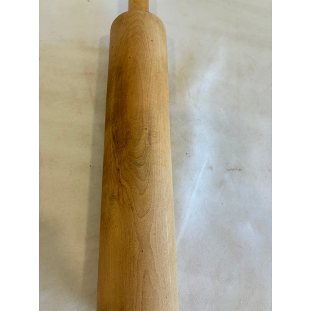 Collection of four vintage wooden rolling pins in assorted sizes and finishes. These classic farmhouse baking tools are...