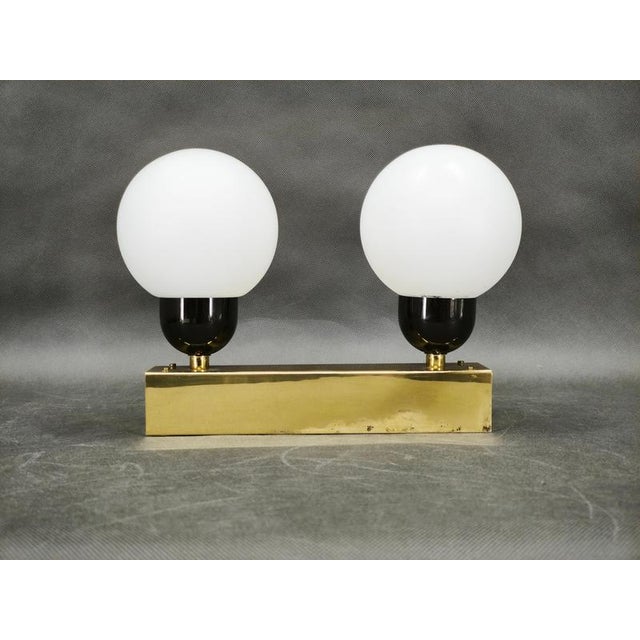 A refined modernist wall light manufactured by kamenický šenov in czechoslovakia during the 1970s. Its elegant...