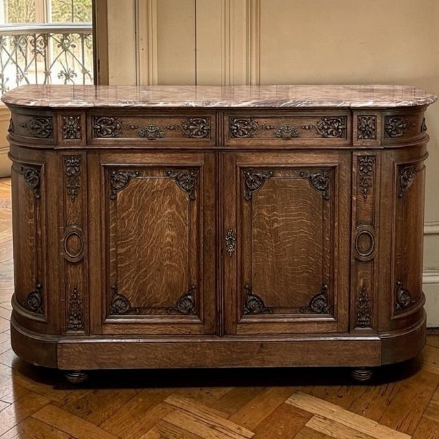 19th Century French Louis XIV Marble Top Buffet represents an elegant blend of neoclassical architecture and hand-carved...