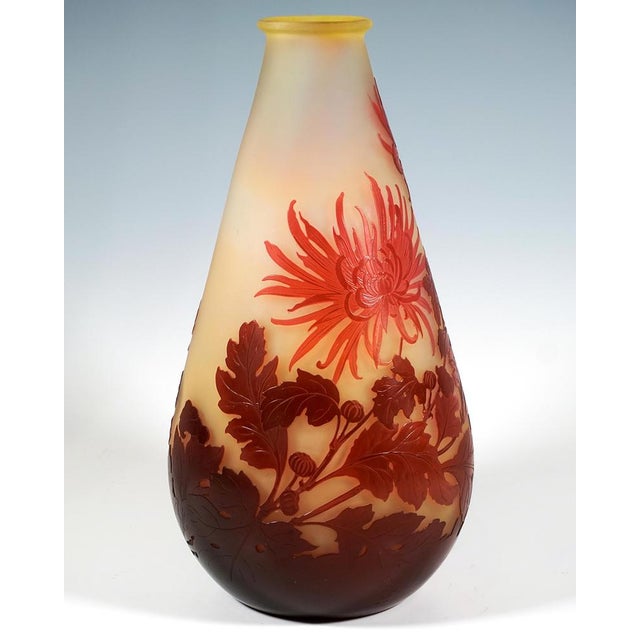 Large teardrop-shaped vase on a flush base, with a narrow opening and flared rim, colourless glass with milky yellow...