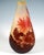 Large teardrop-shaped vase on a flush base, with a narrow opening and flared rim, colourless glass with milky yellow...