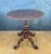 20th-century Victorian tilt-top pedestal table featuring a rotating circular top with a finely scalloped edge. The table...