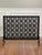 Offering an Arts and Crafts cast brass and iron single panel fire screen with a lattice design of oak leaf garlands and...